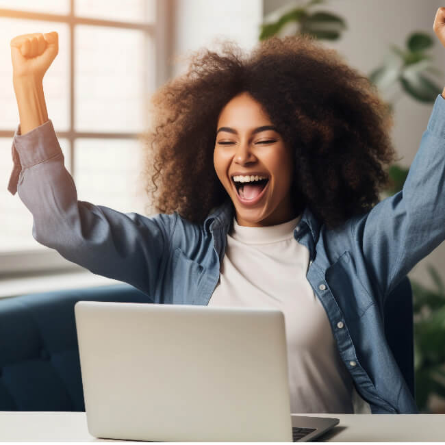 woman in front of the computer celebrating